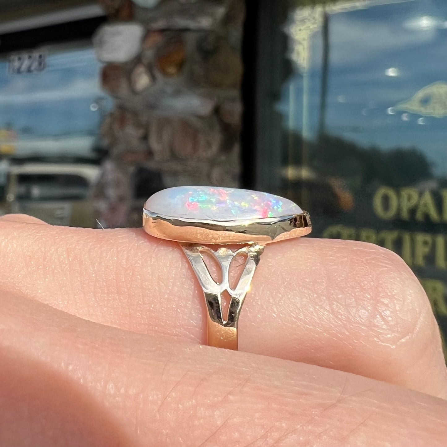 A ladies' pear shaped white crystal opal solitaire ring handmade in yellow gold.
