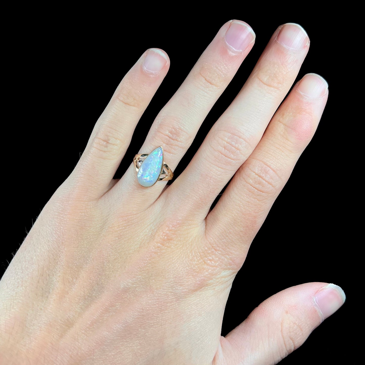 A ladies' pear shaped white crystal opal solitaire ring handmade in yellow gold.