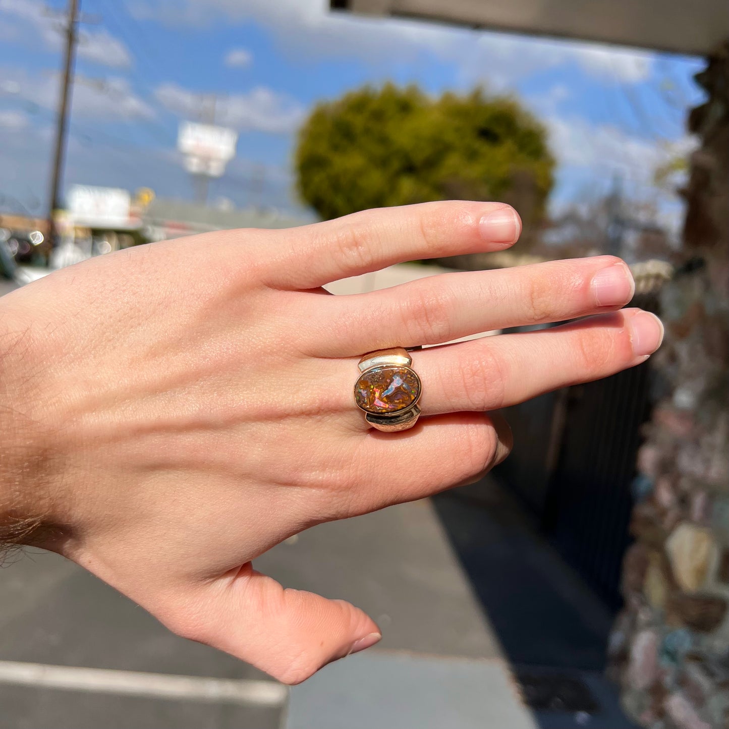 A Koroit boulder opal men's ring in brushed yellow gold.