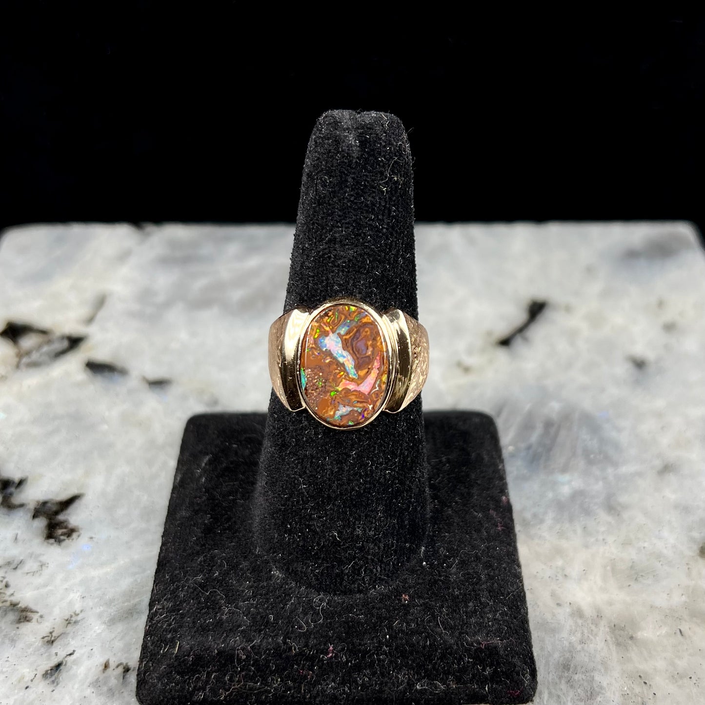A Koroit boulder opal men's ring in brushed yellow gold.
