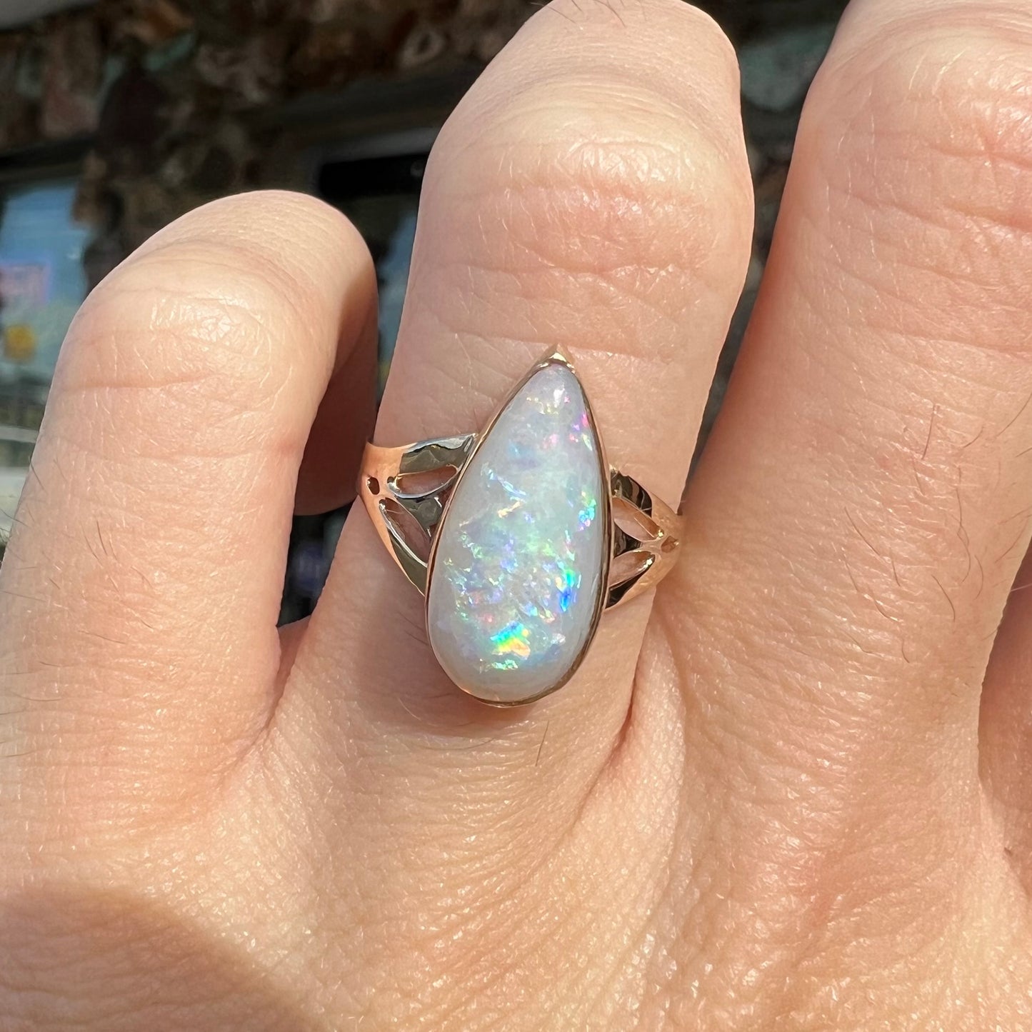 A ladies' pear shaped white crystal opal solitaire ring handmade in yellow gold.