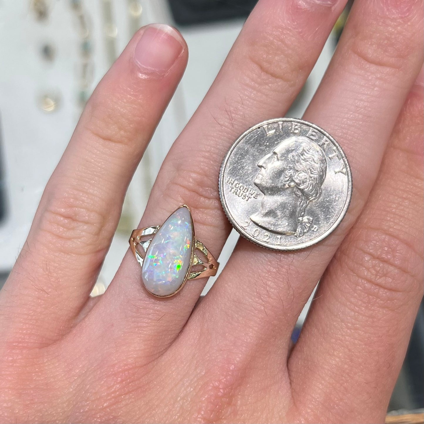 A ladies' pear shaped white crystal opal solitaire ring handmade in yellow gold.