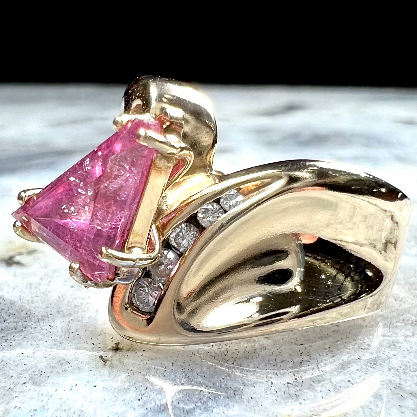An estate yellow gold and diamond triangle cut Pala pink tourmaline ladies' ring.