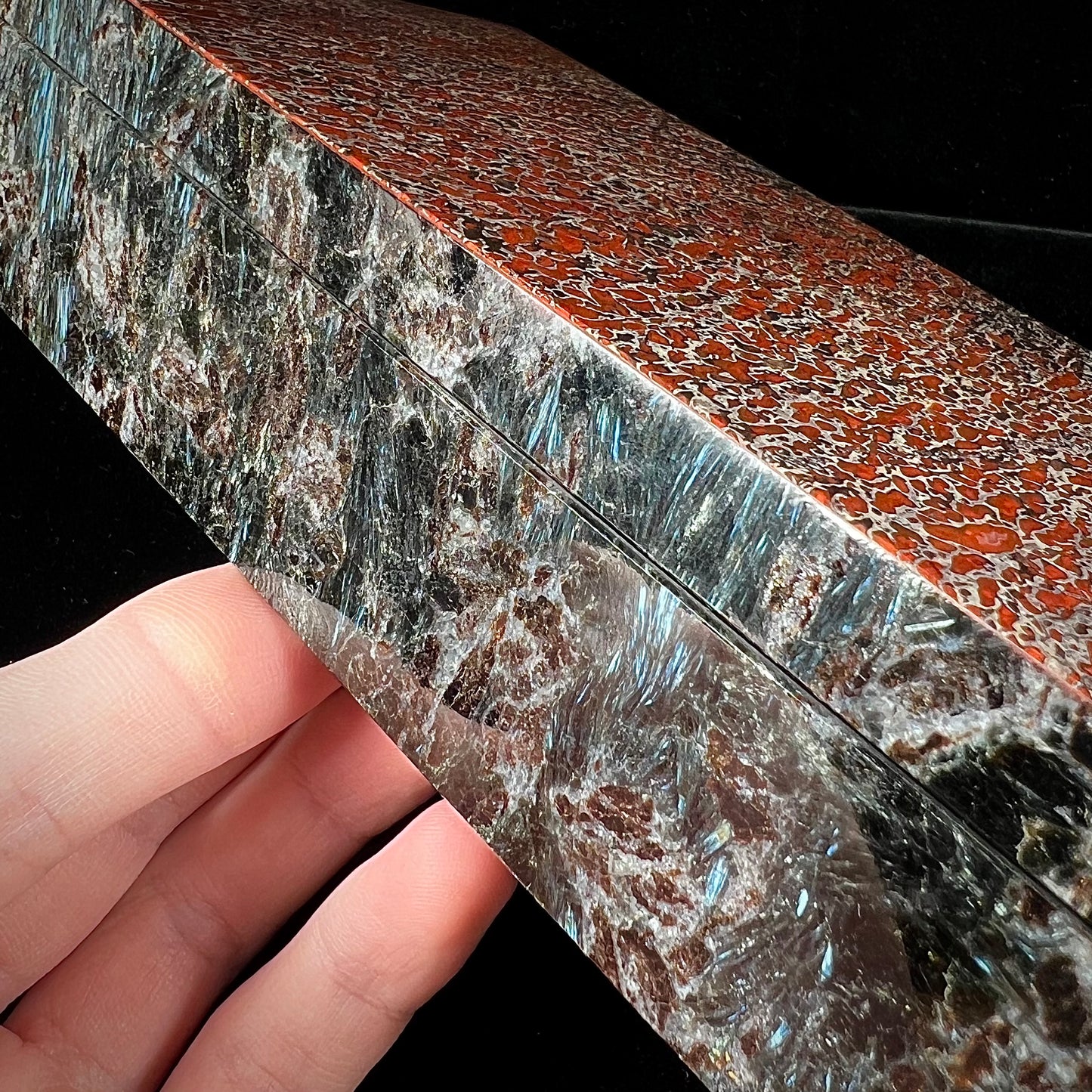 A custom stone box handmade by Gems Art Studio from polished red dinosaur bone and blue pietersite.