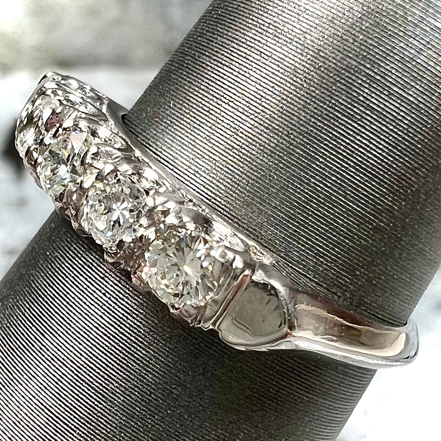A vintage style ladies' platinum wedding band set with five round diamonds.