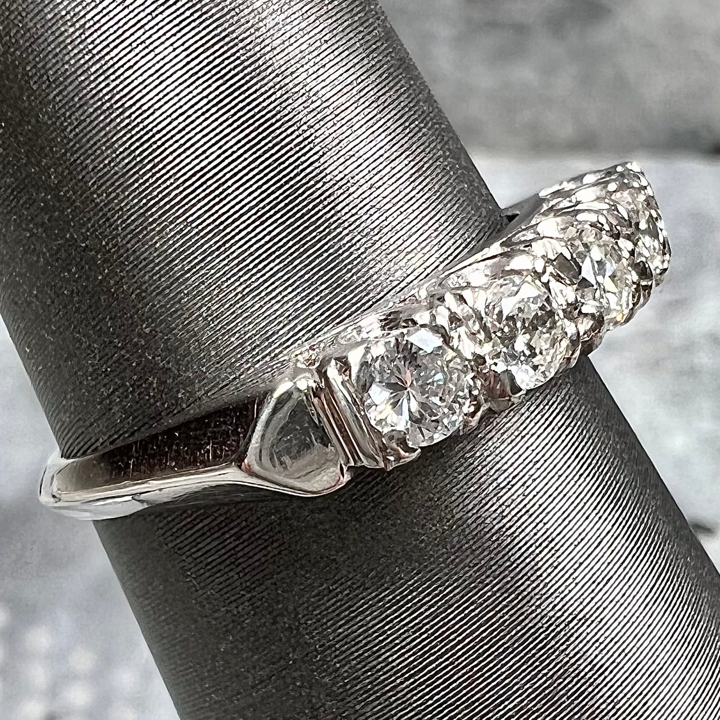 A vintage style ladies' platinum wedding band set with five round diamonds.