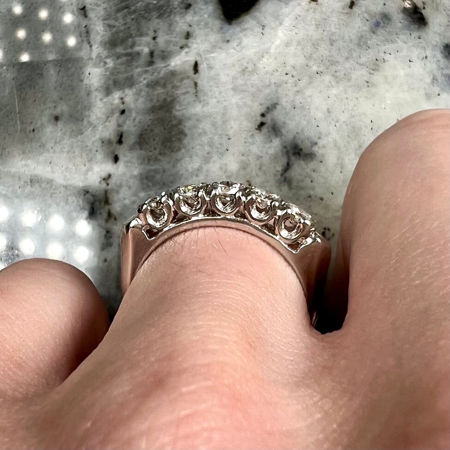A vintage style ladies' platinum wedding band set with five round diamonds.