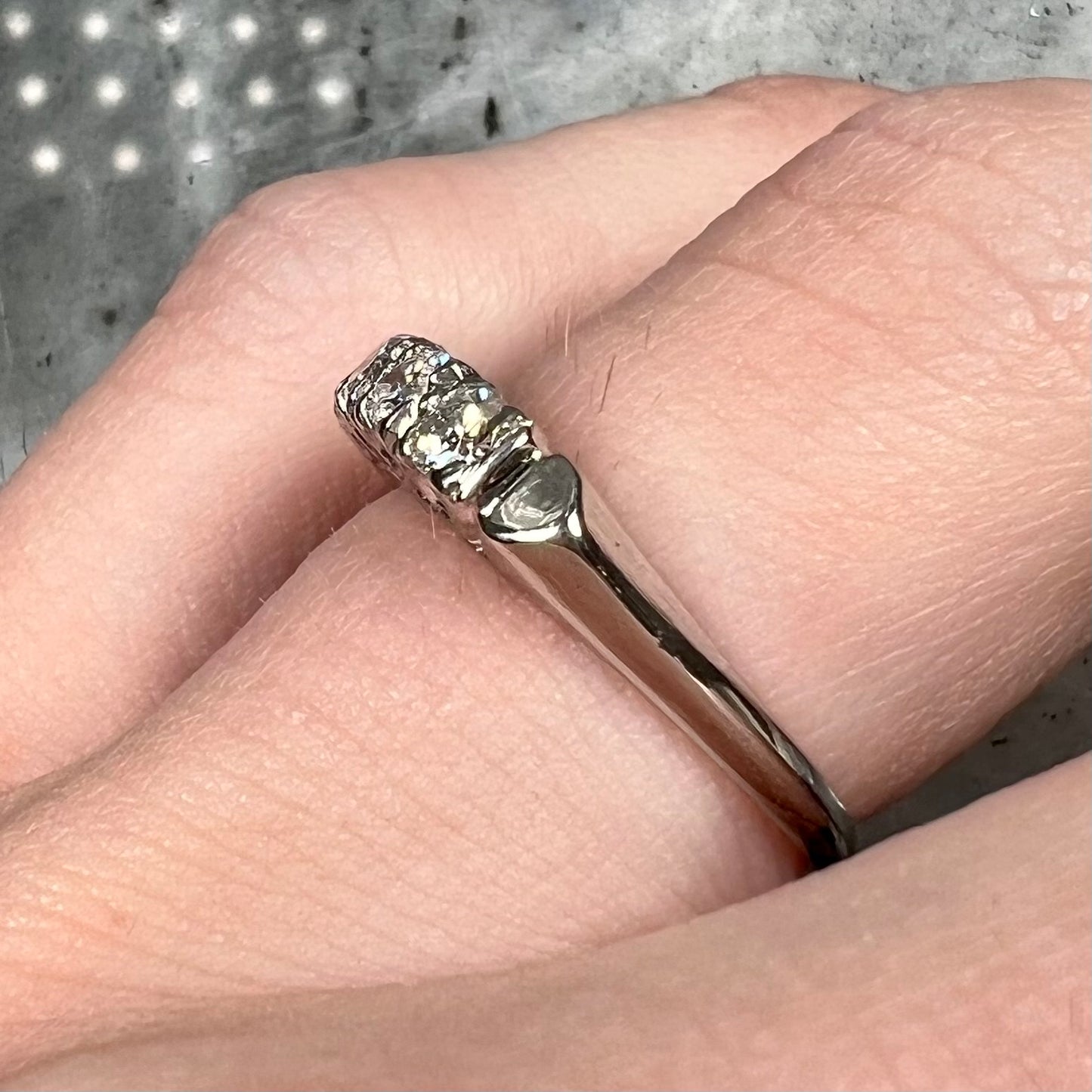 A vintage style ladies' platinum wedding band set with five round diamonds.