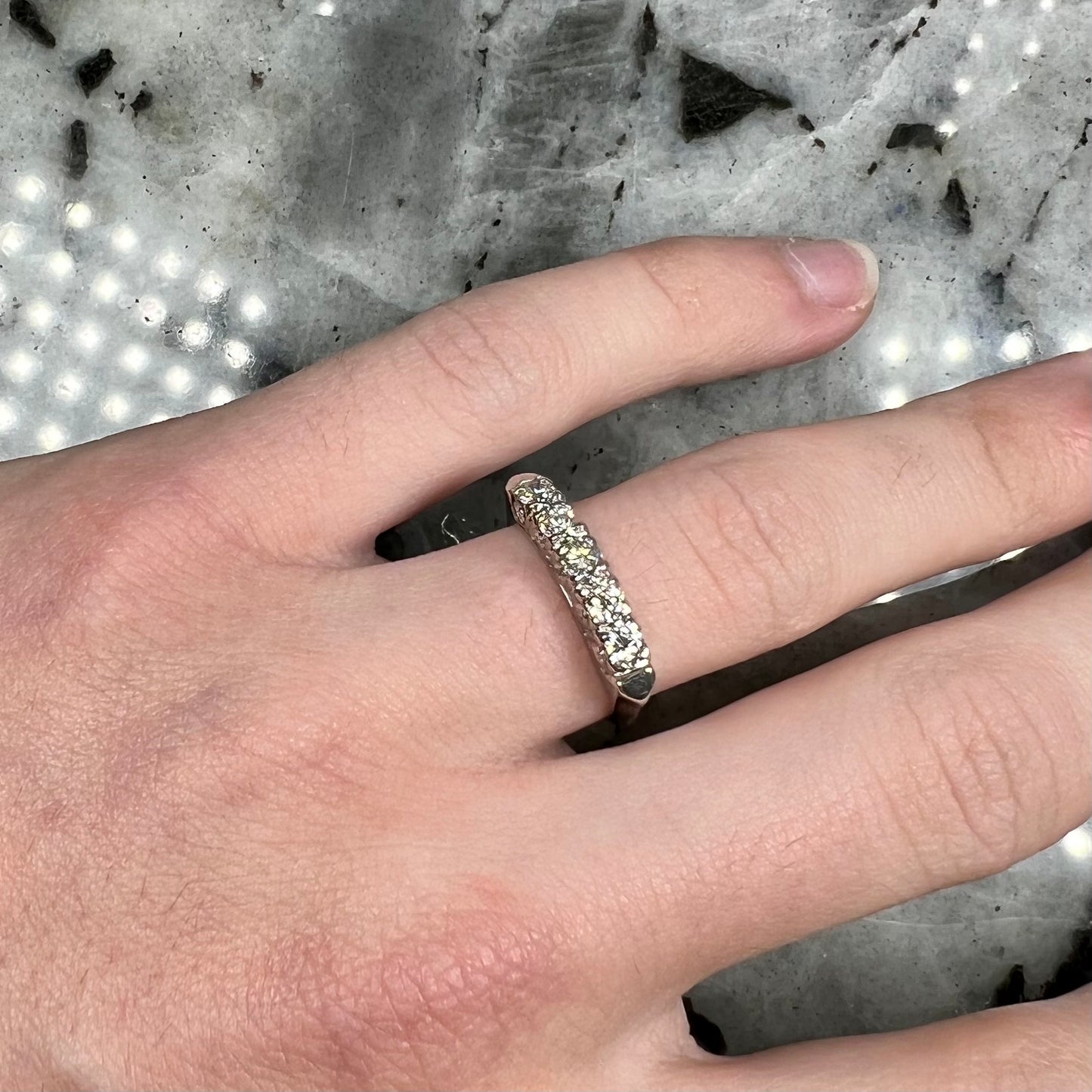 A vintage style ladies' platinum wedding band set with five round diamonds.