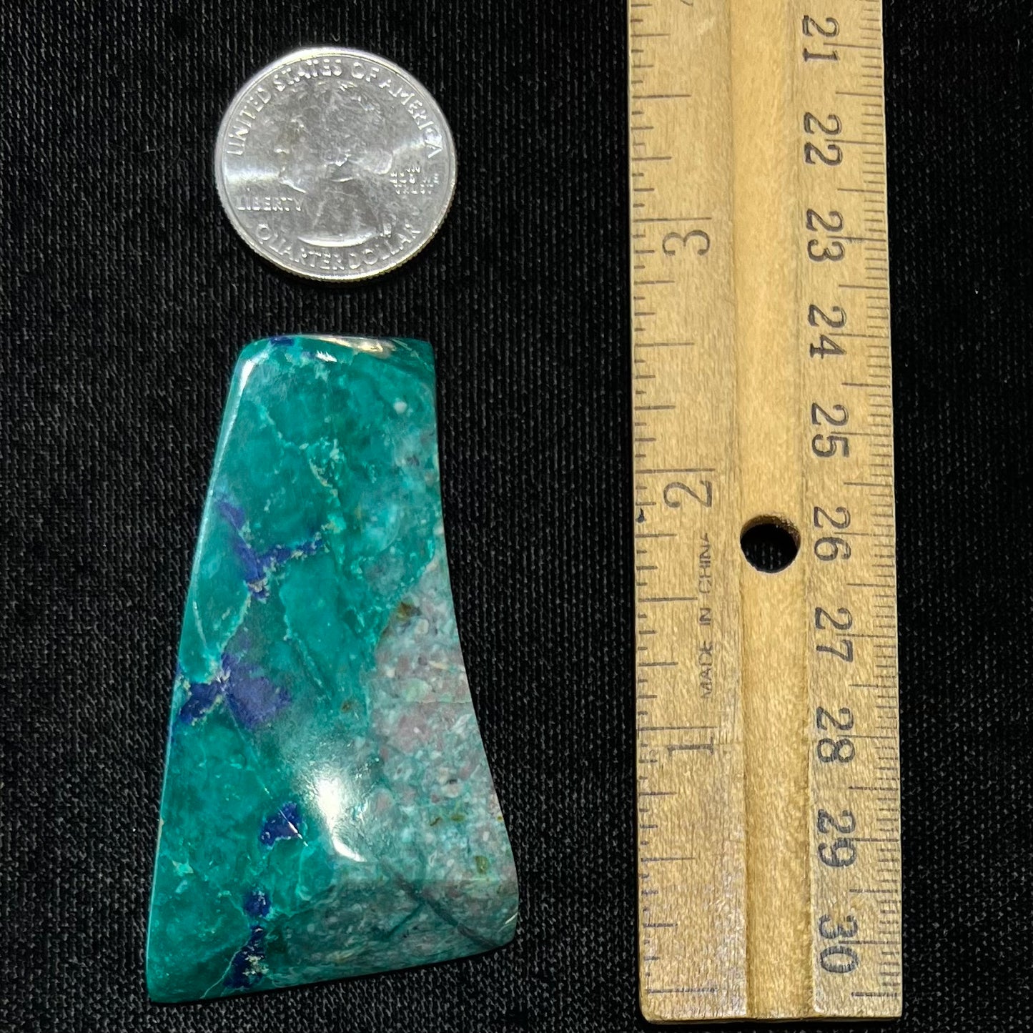 A loose polished sculpture of green chrysocolla with blue azurite inclusions.