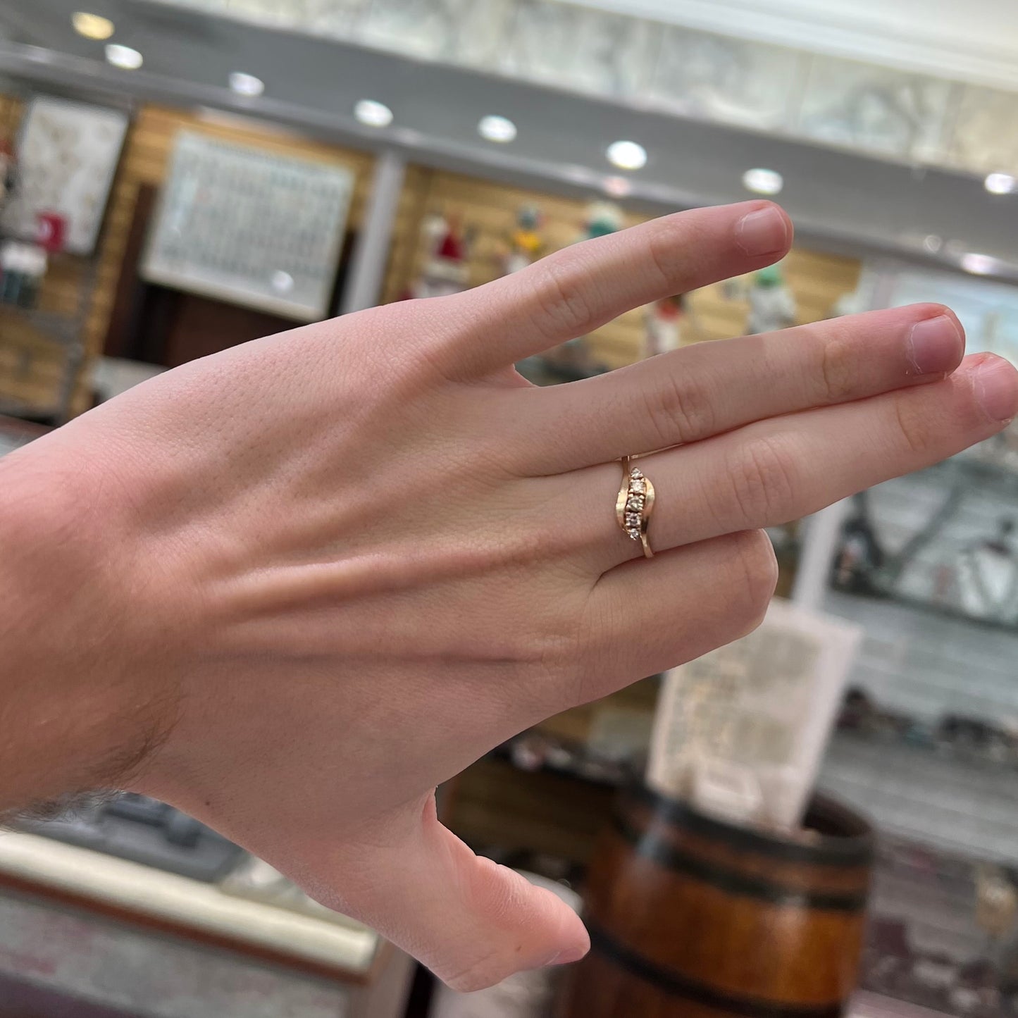 A yellow gold ladies' promise ring set with five Standard Round Brilliant Cut diamonds.