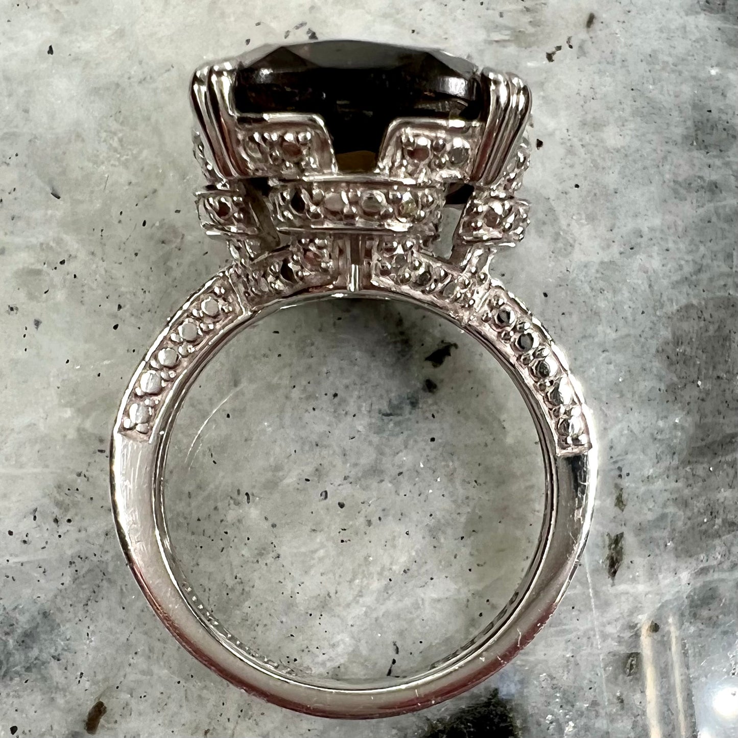 A sterling silver, cushion cut smoky quartz solitaire ring.