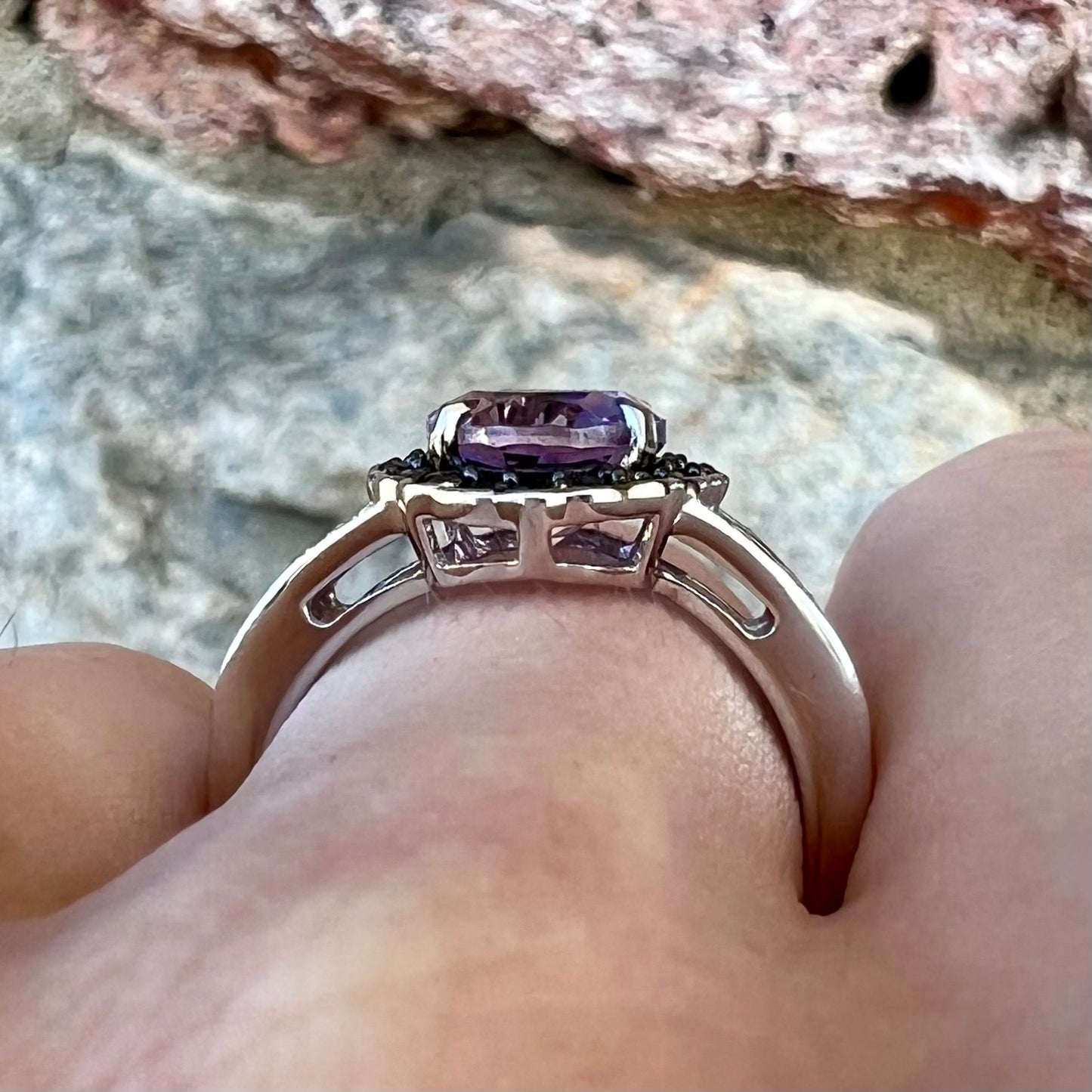 Sterling silver ladies' ring made with Rose de France amethyst set in a black spinel halo with white topaz accents.