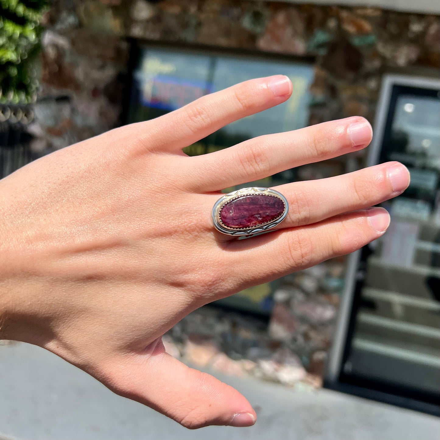 A sterling silver Navajo style ring set with a purple spiny oyster shell.