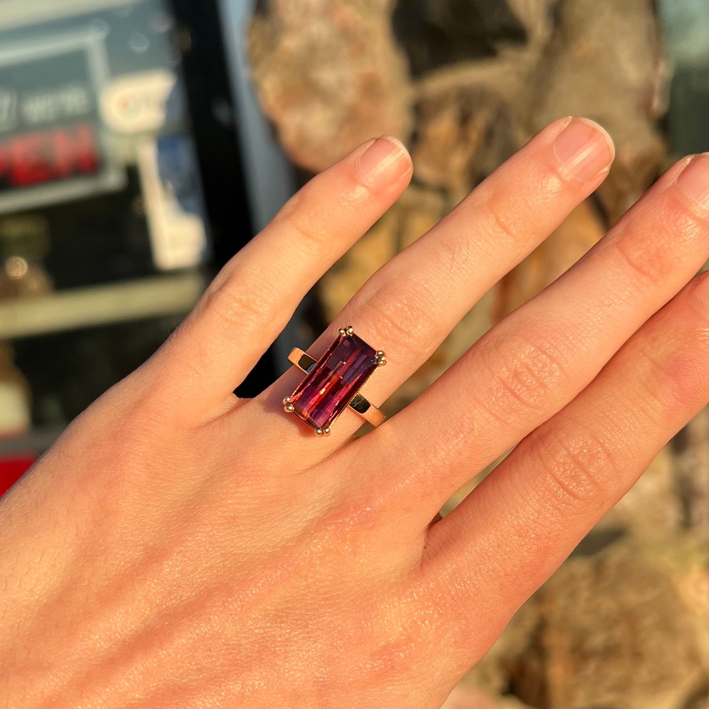 A handmade yellow gold solitaire ring set with a 7.91ct pinkish purple pixel cut tourmaline stone.