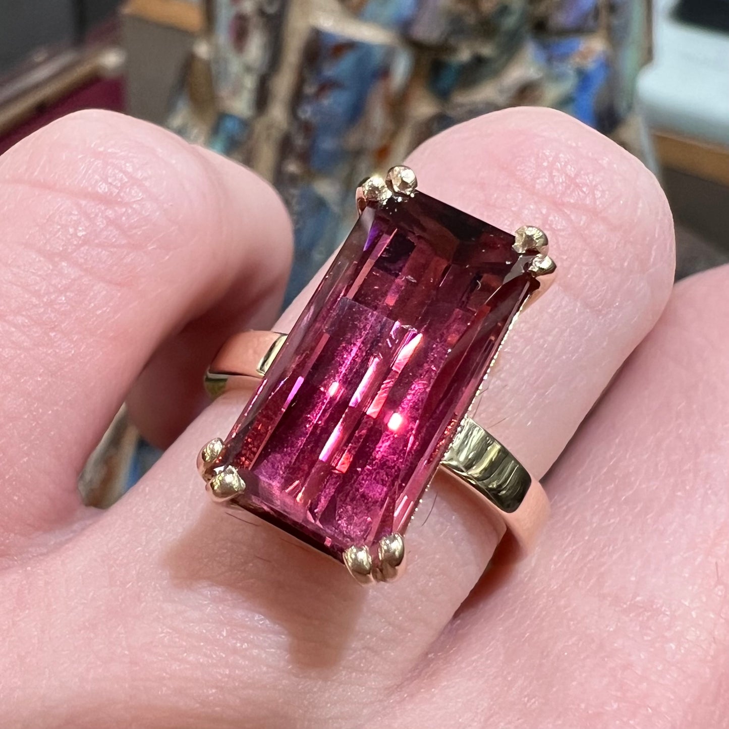 A handmade yellow gold solitaire ring set with a 7.91ct pinkish purple pixel cut tourmaline stone.