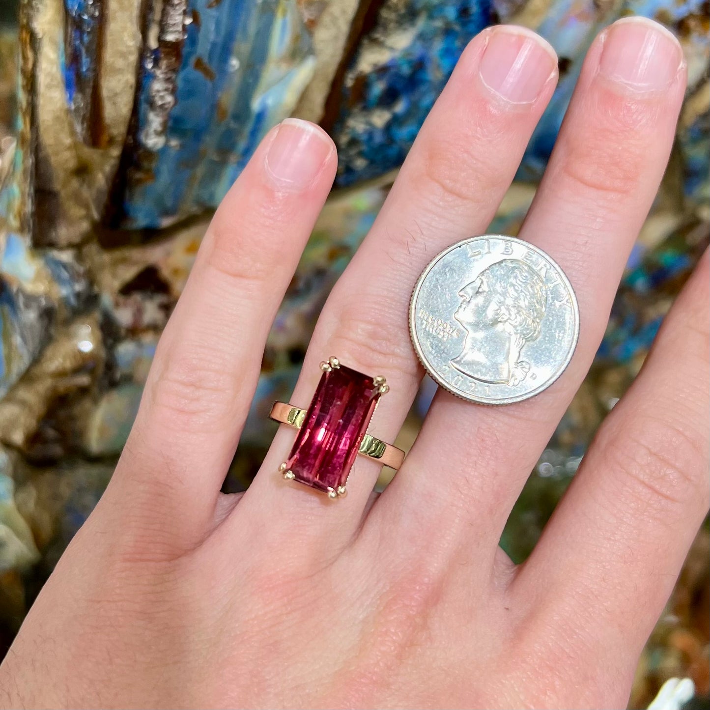 A handmade yellow gold solitaire ring set with a 7.91ct pinkish purple pixel cut tourmaline stone.