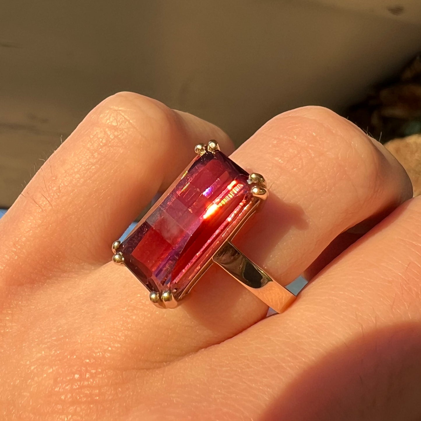 A handmade yellow gold solitaire ring set with a 7.91ct pinkish purple pixel cut tourmaline stone.