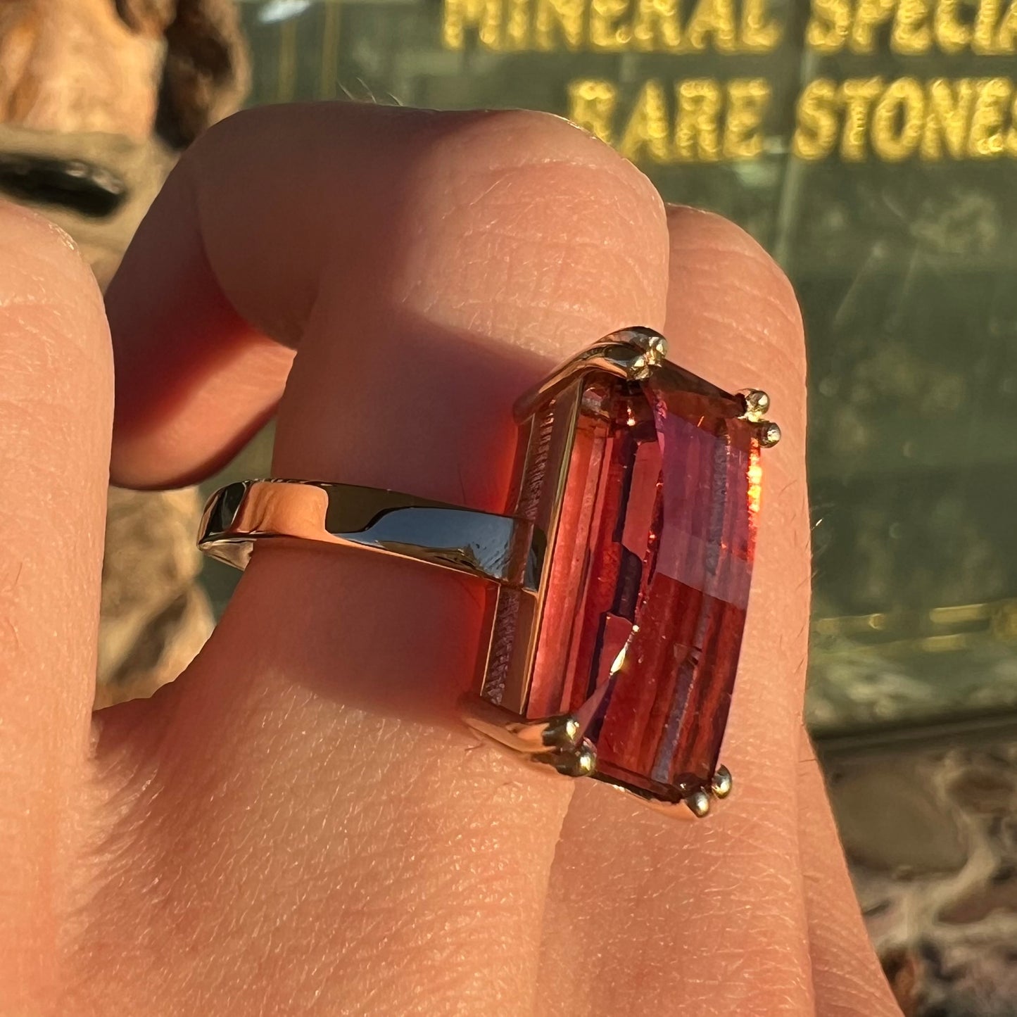 A handmade yellow gold solitaire ring set with a 7.91ct pinkish purple pixel cut tourmaline stone.