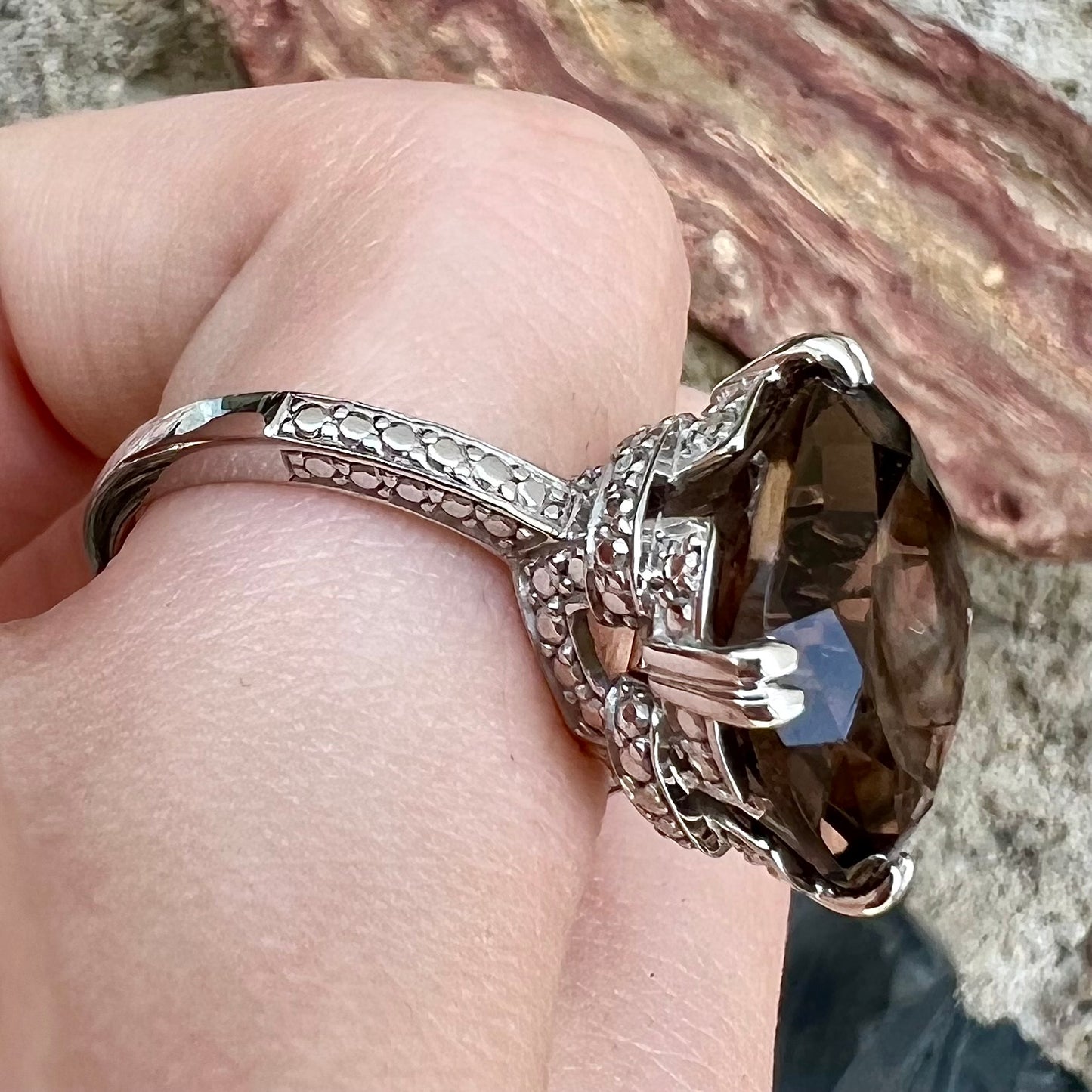 A sterling silver, cushion cut smoky quartz solitaire ring.