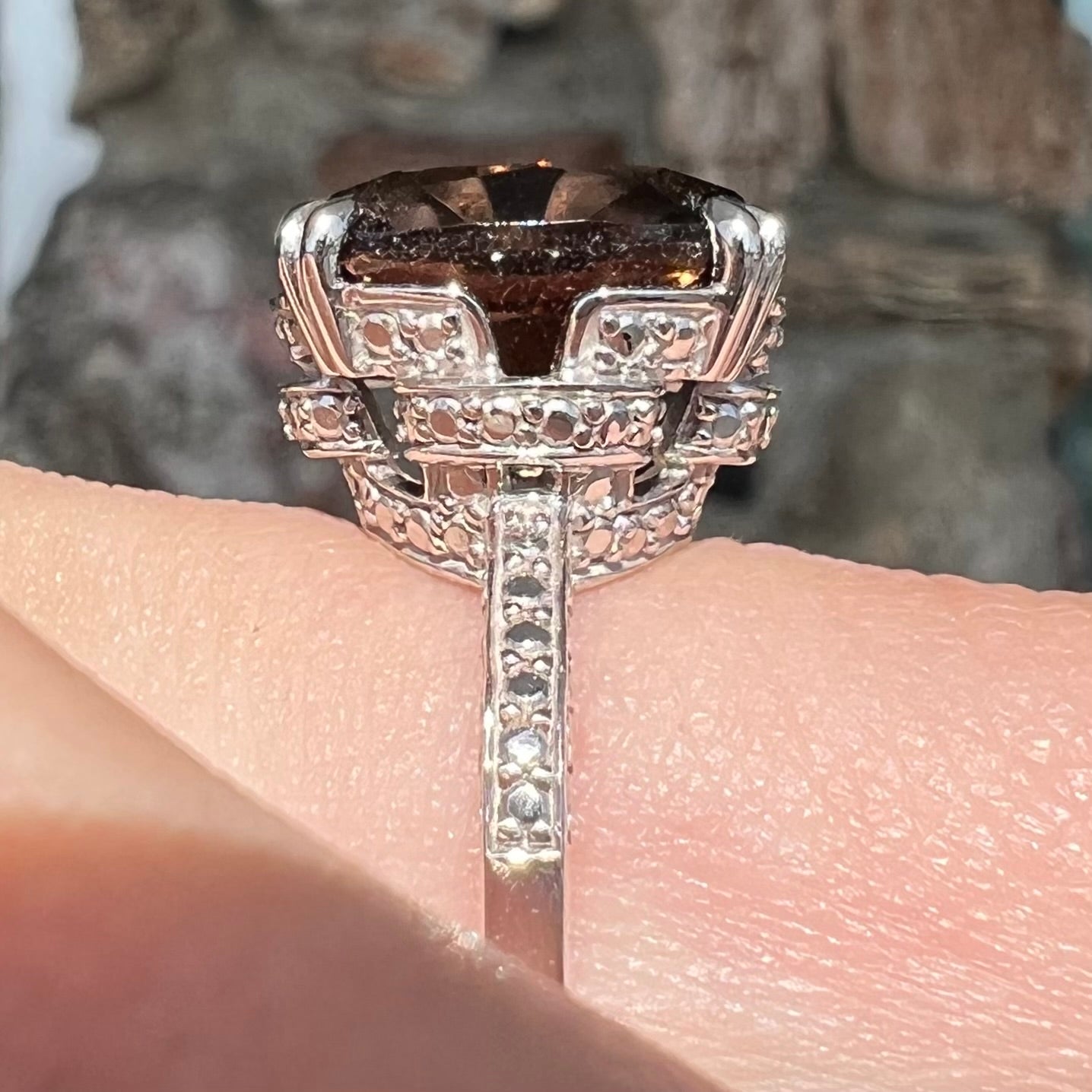 A sterling silver, cushion cut smoky quartz solitaire ring.