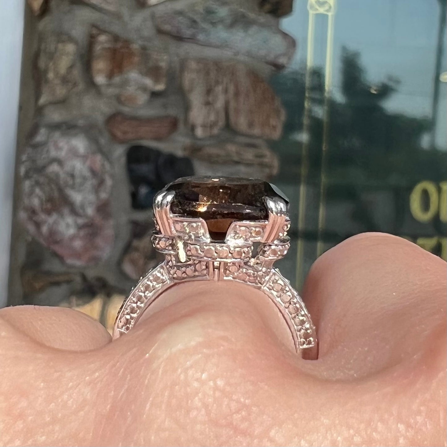 A sterling silver, cushion cut smoky quartz solitaire ring.