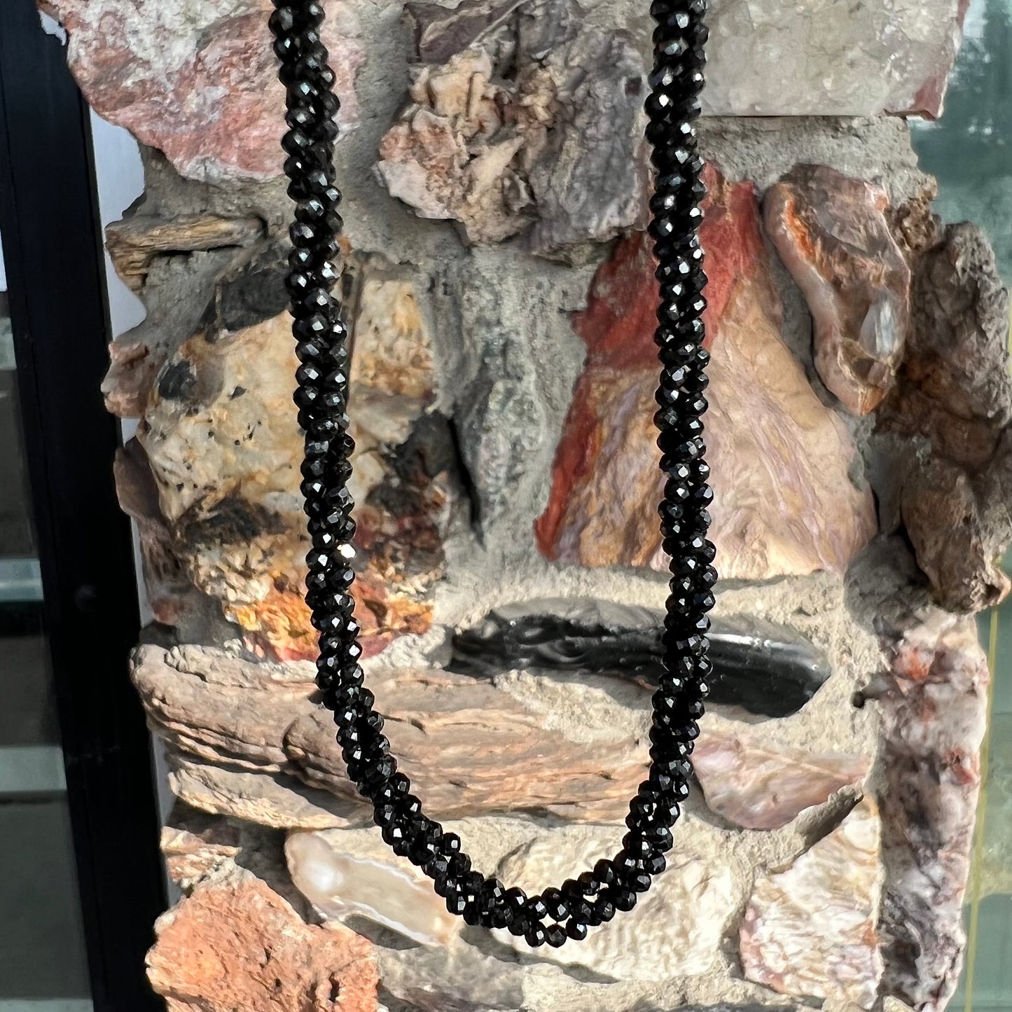 A beaded necklace made of black spinel.