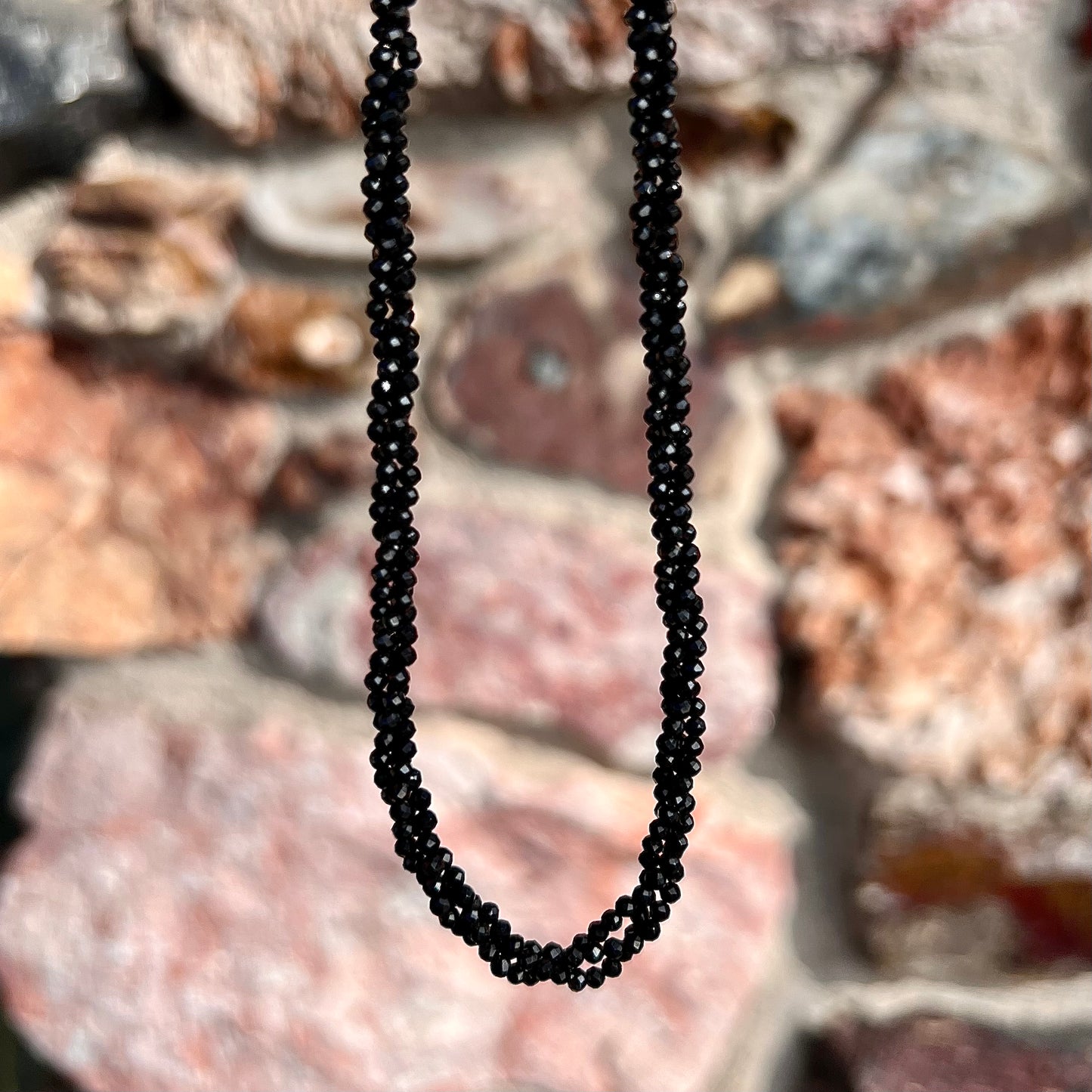 A beaded necklace made of black spinel.