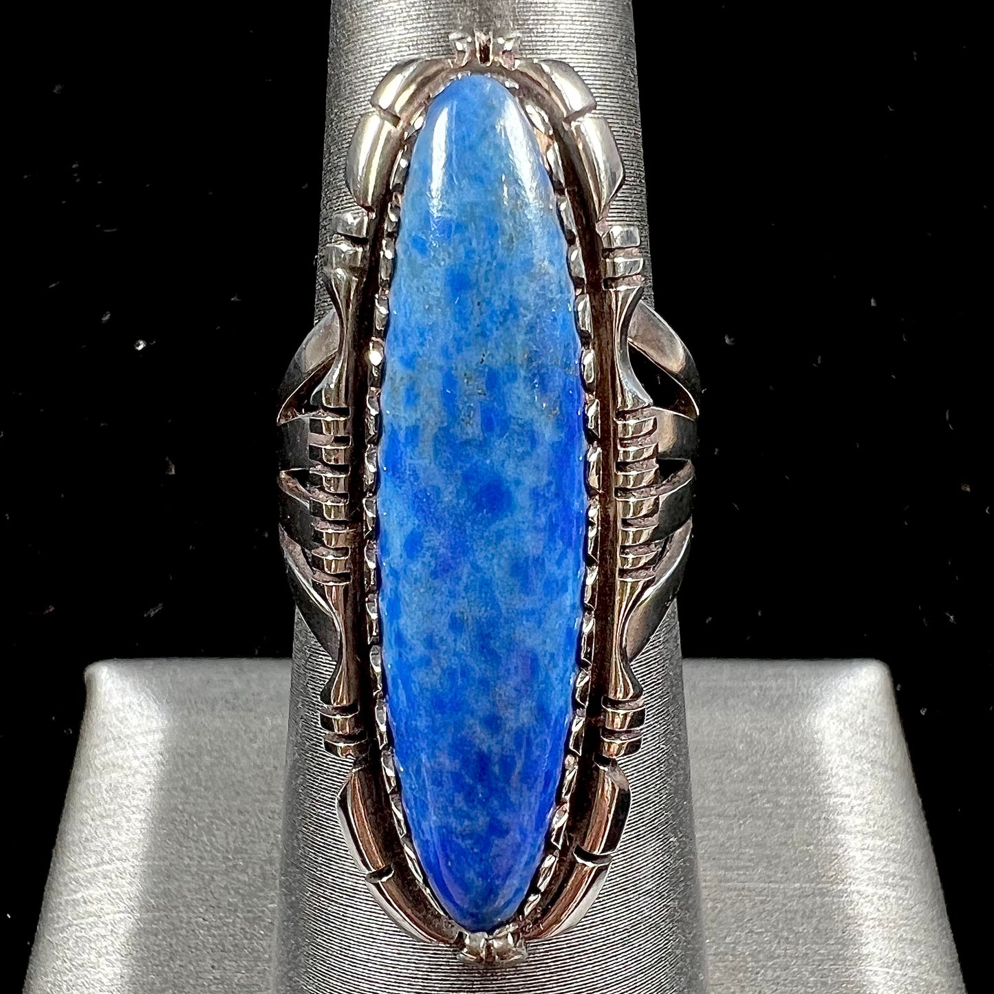 A Navajo style sterling silver lapis lazuli ring engraved with the words "R. Bennett".