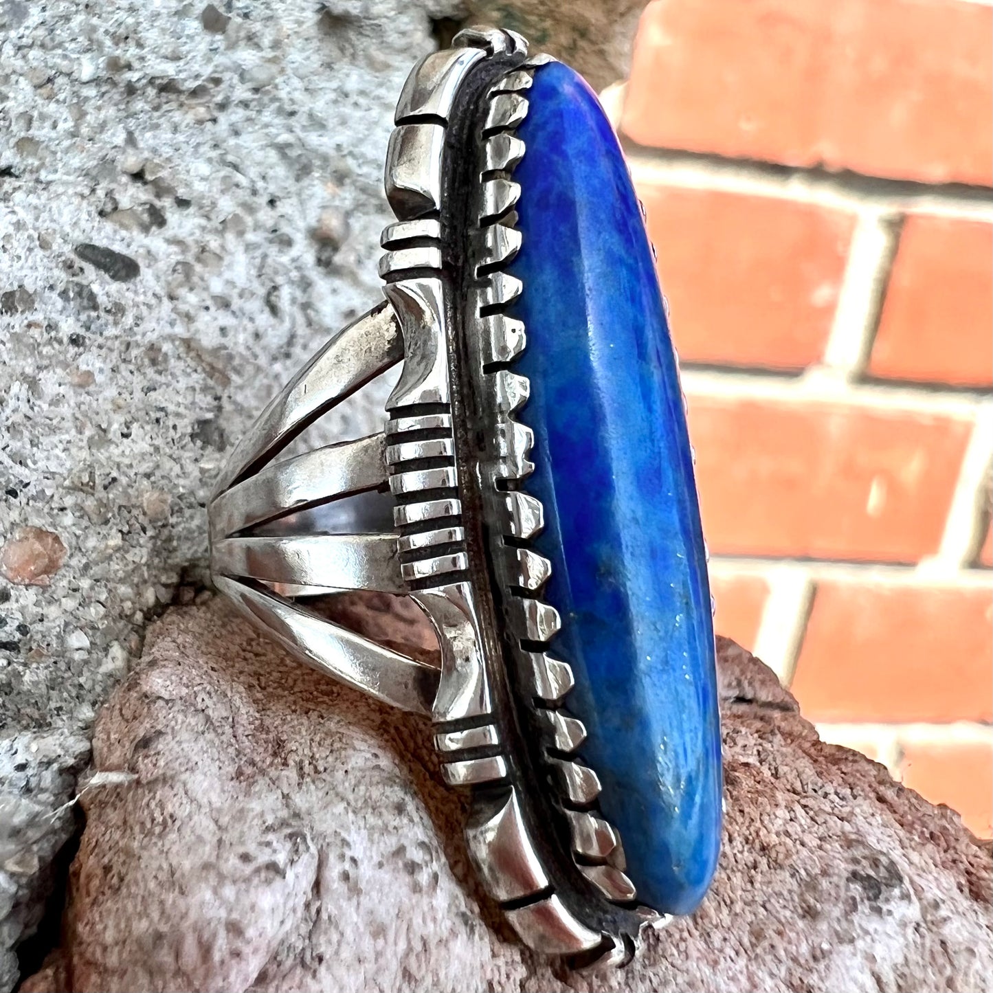 A Navajo style sterling silver lapis lazuli ring engraved with the words "R. Bennett".