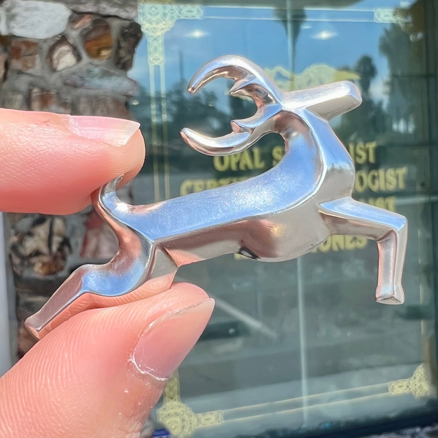 A silver brooch of a jumping deer handmade by Navajo artist Frances Jones.