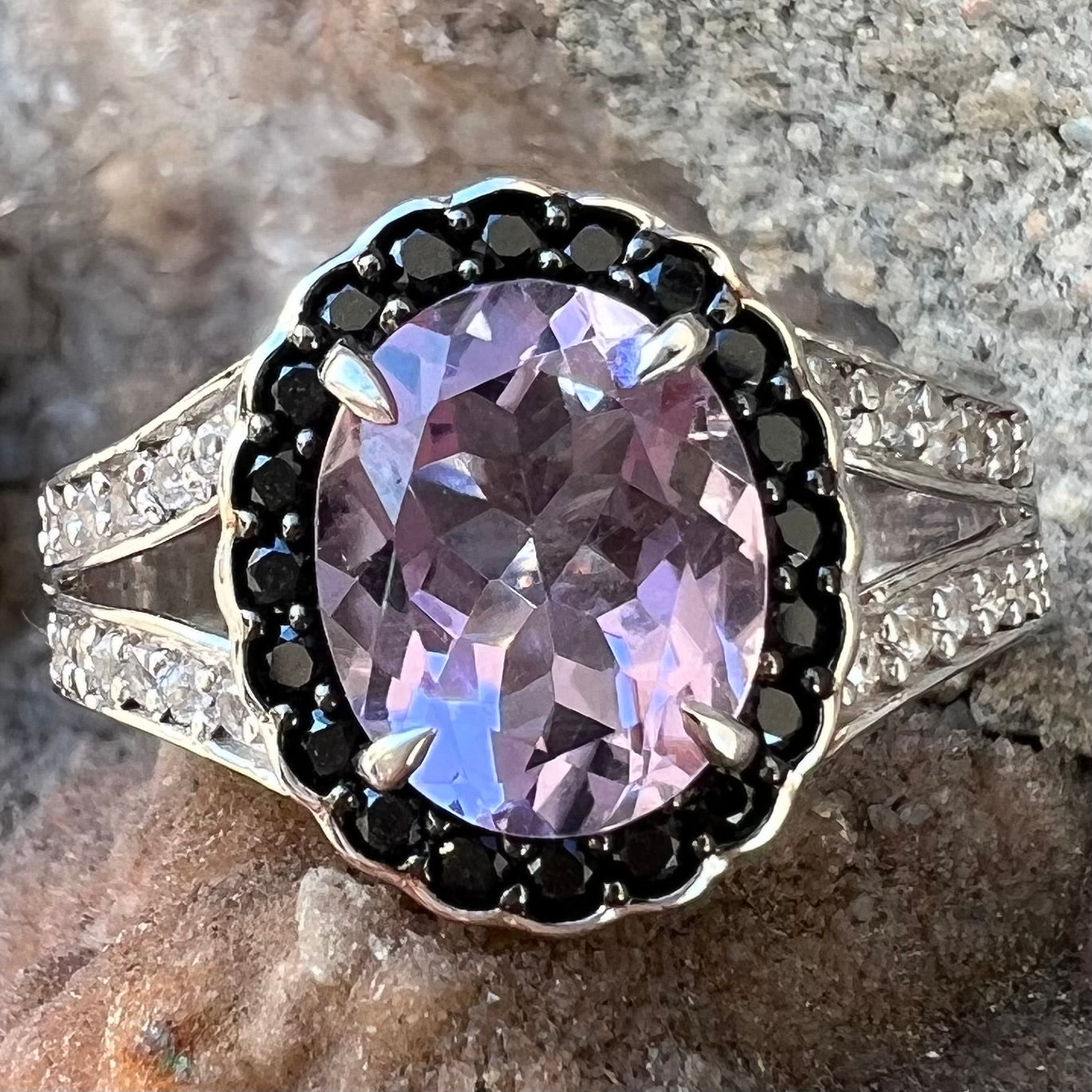 Sterling silver ladies' ring made with Rose de France amethyst set in a black spinel halo with white topaz accents.