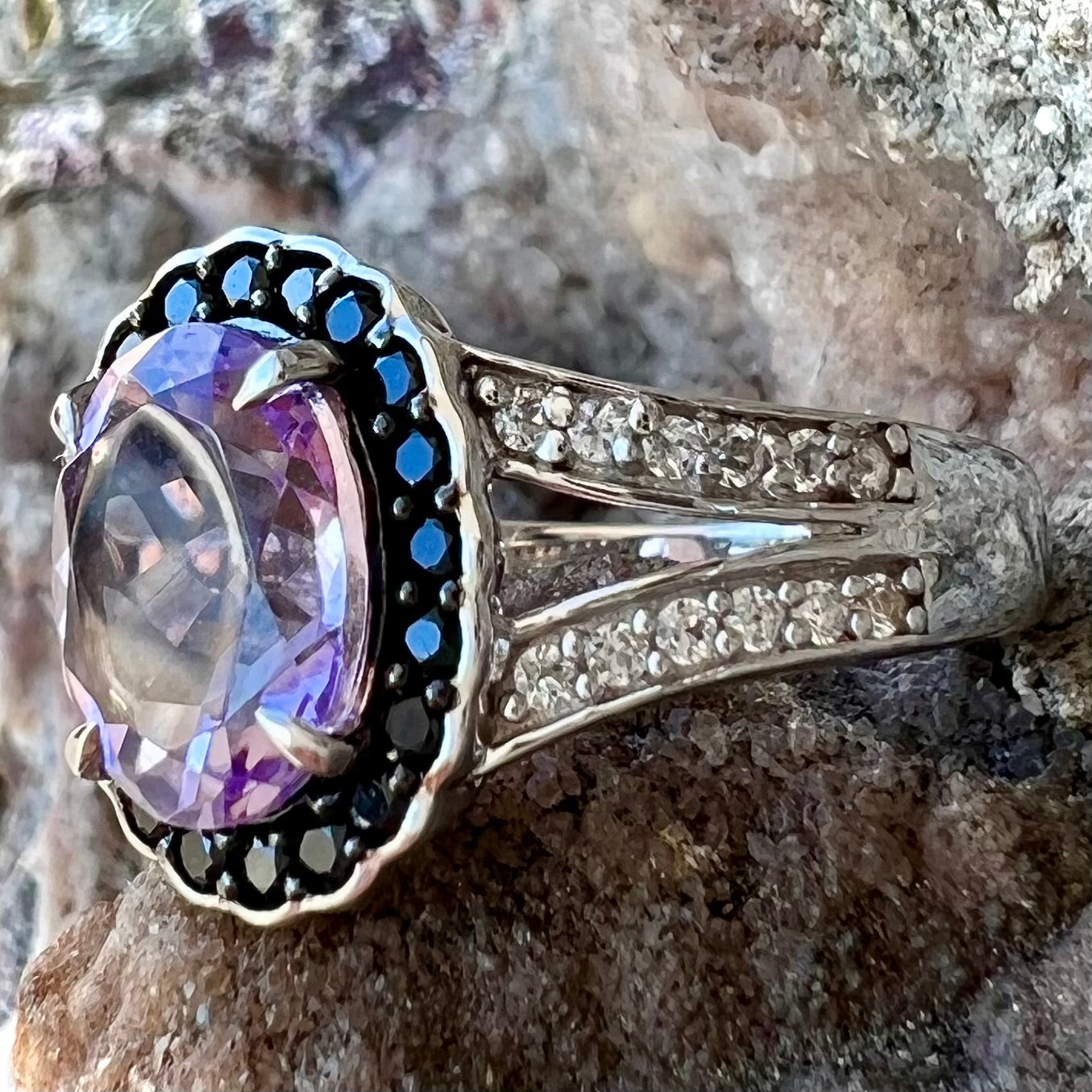 Sterling silver ladies' ring made with Rose de France amethyst set in a black spinel halo with white topaz accents.