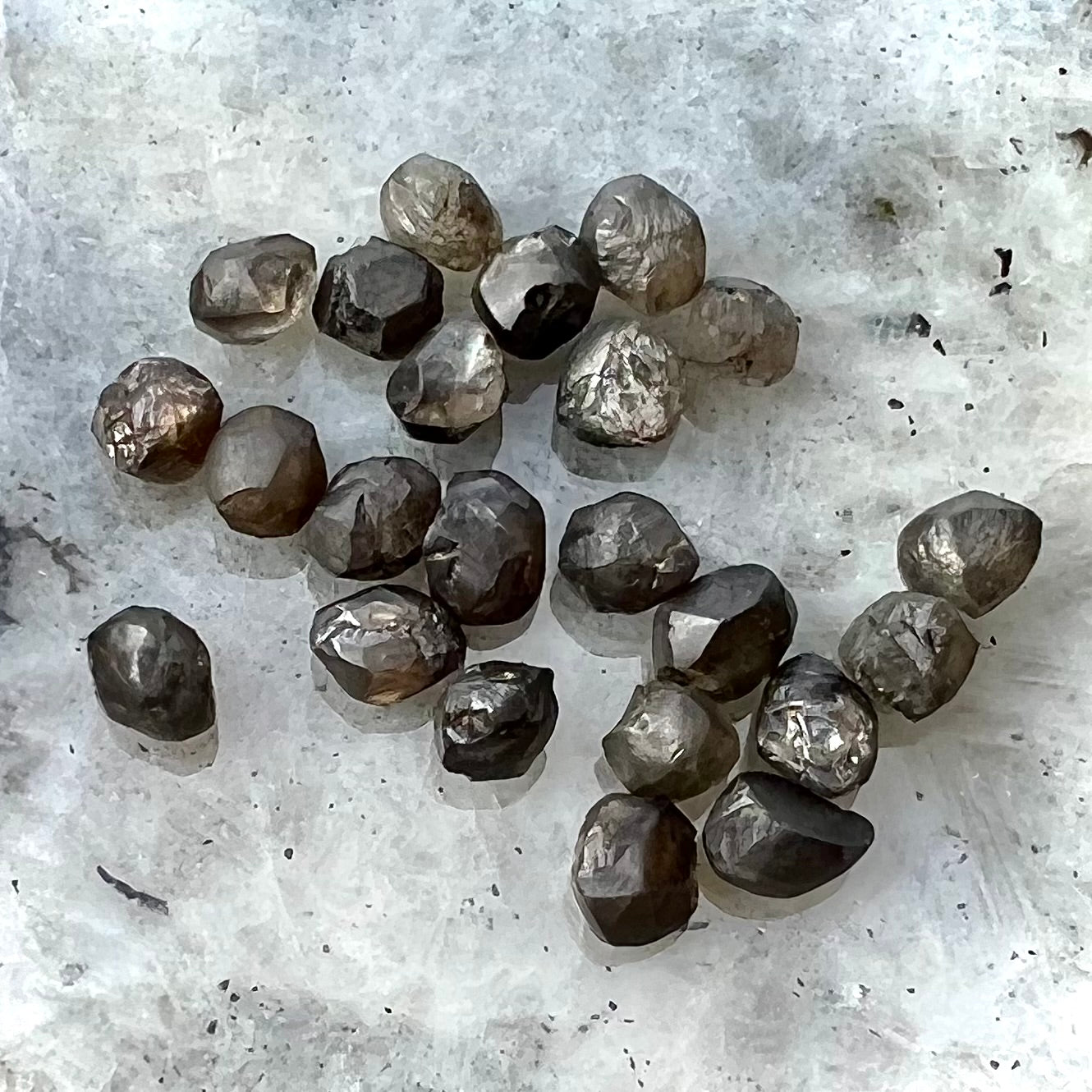 Natural black diamond crystals of different shapes and sizes.