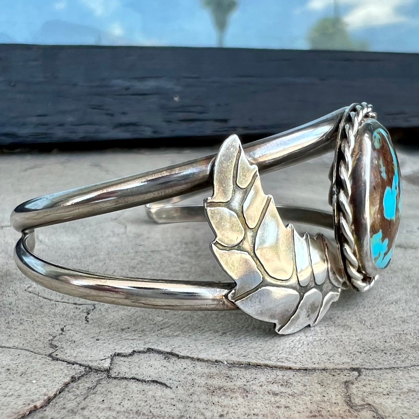 A sterling silver Navajo cuff bracelet set with a Royston turquoise stone.