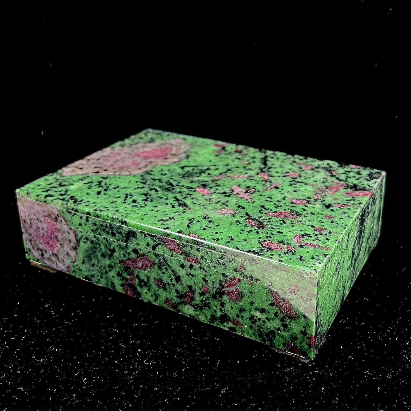 A stone box carved from Ruby in Zoisite stone and lined with green felt.