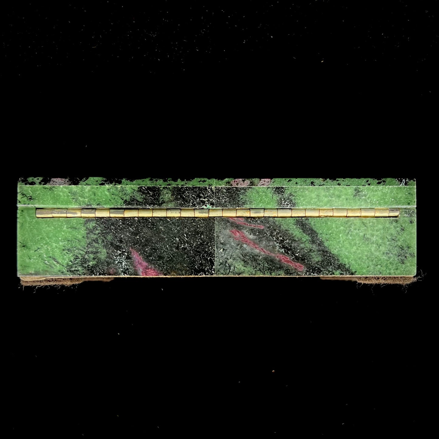 A stone box carved from Ruby in Zoisite stone and lined with green felt.