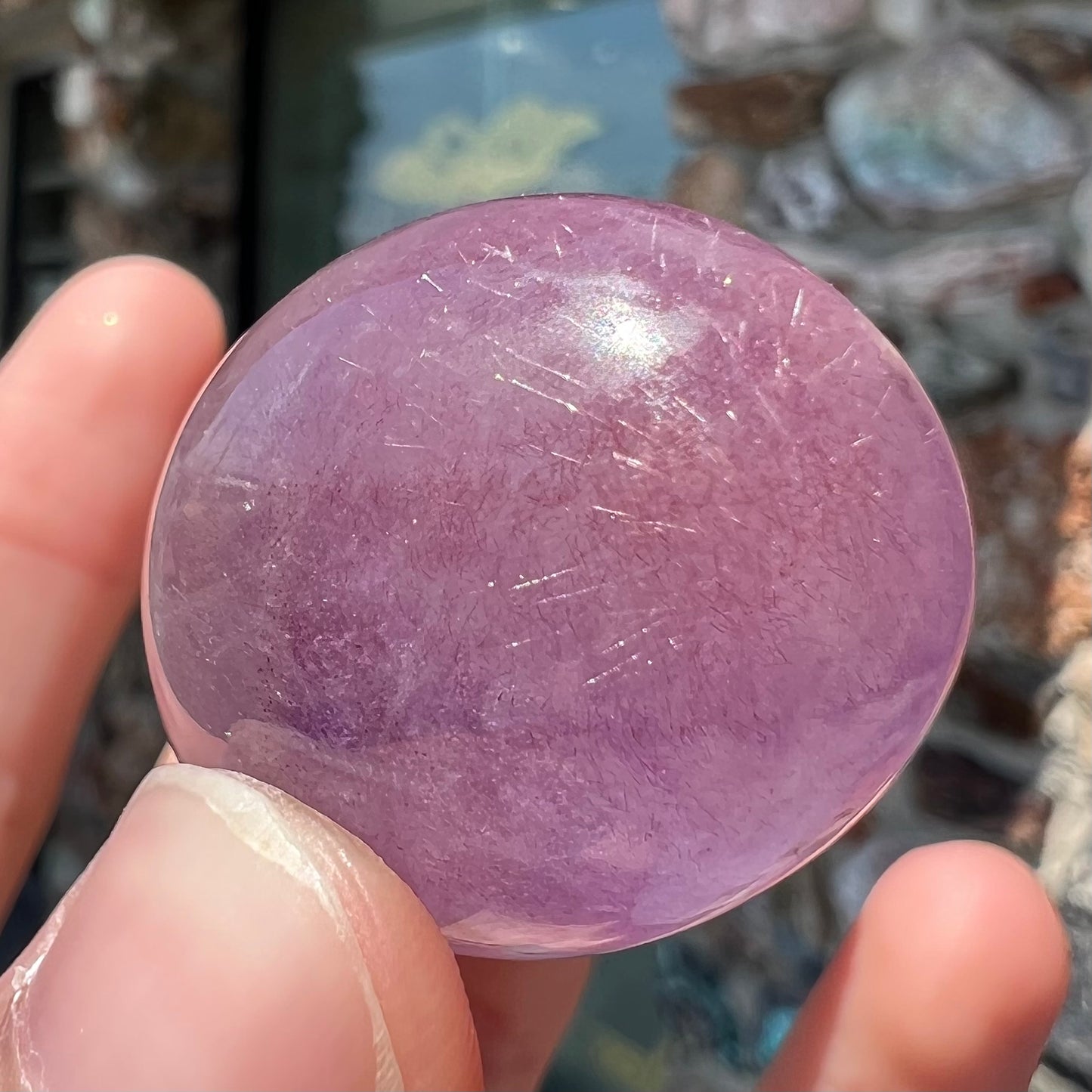 A cabochon cut red amethyst stone from Mexico. The piece shows a faint star.