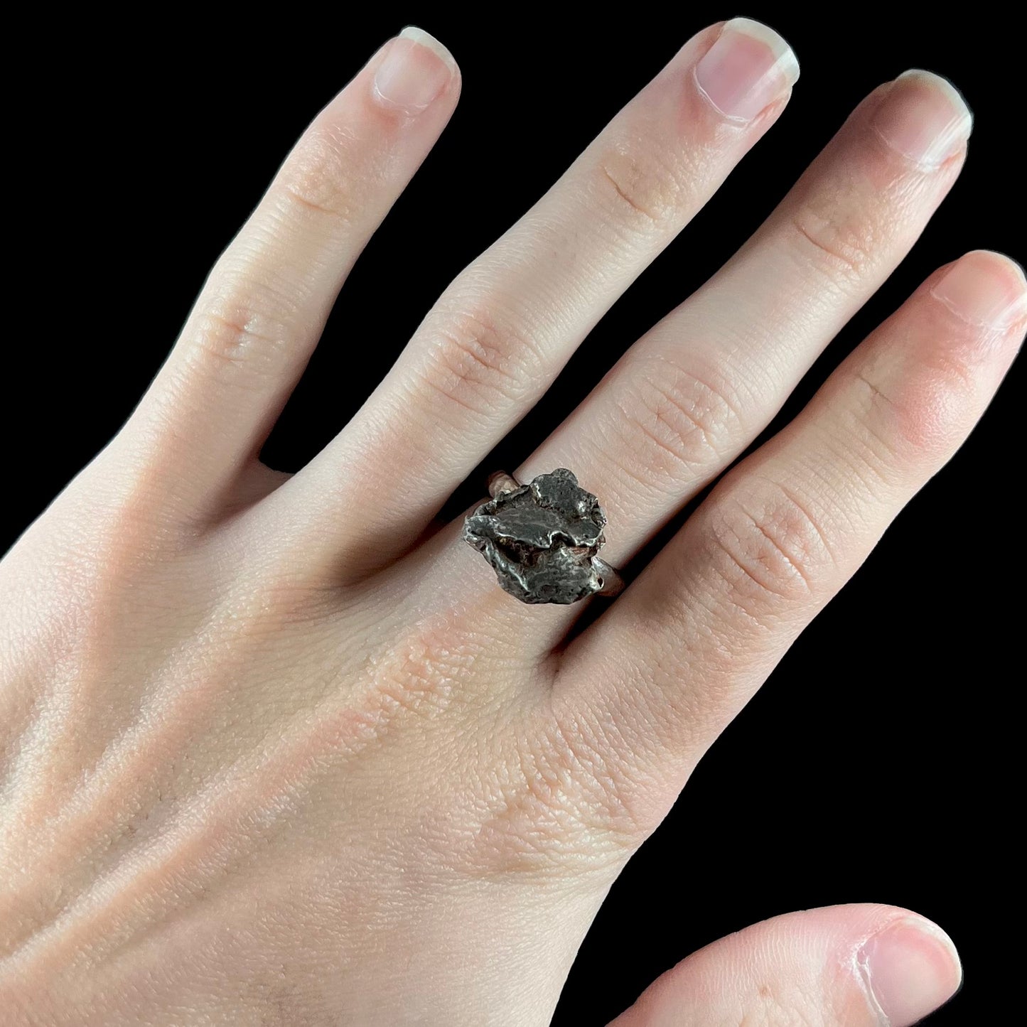 A sterling silver ring set with a Campo del Cielo meteorite.