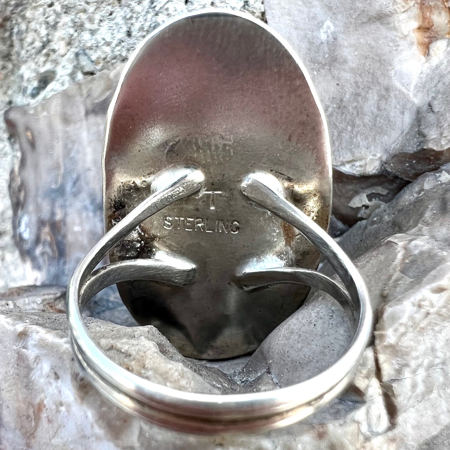A sterling silver Navajo style ring set with a purple spiny oyster shell.