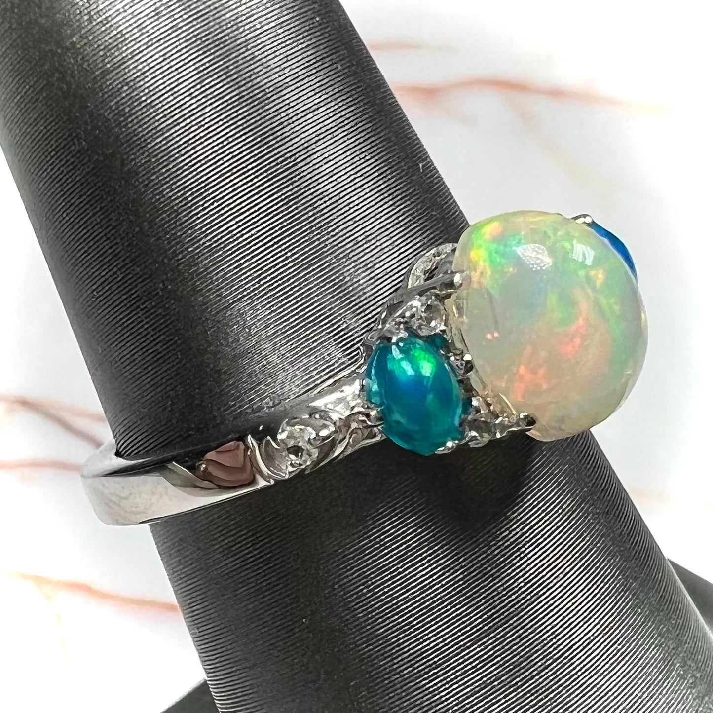 A sterling silver ring, earring, and necklace set made of Ethiopian opals and cubic zirconia.