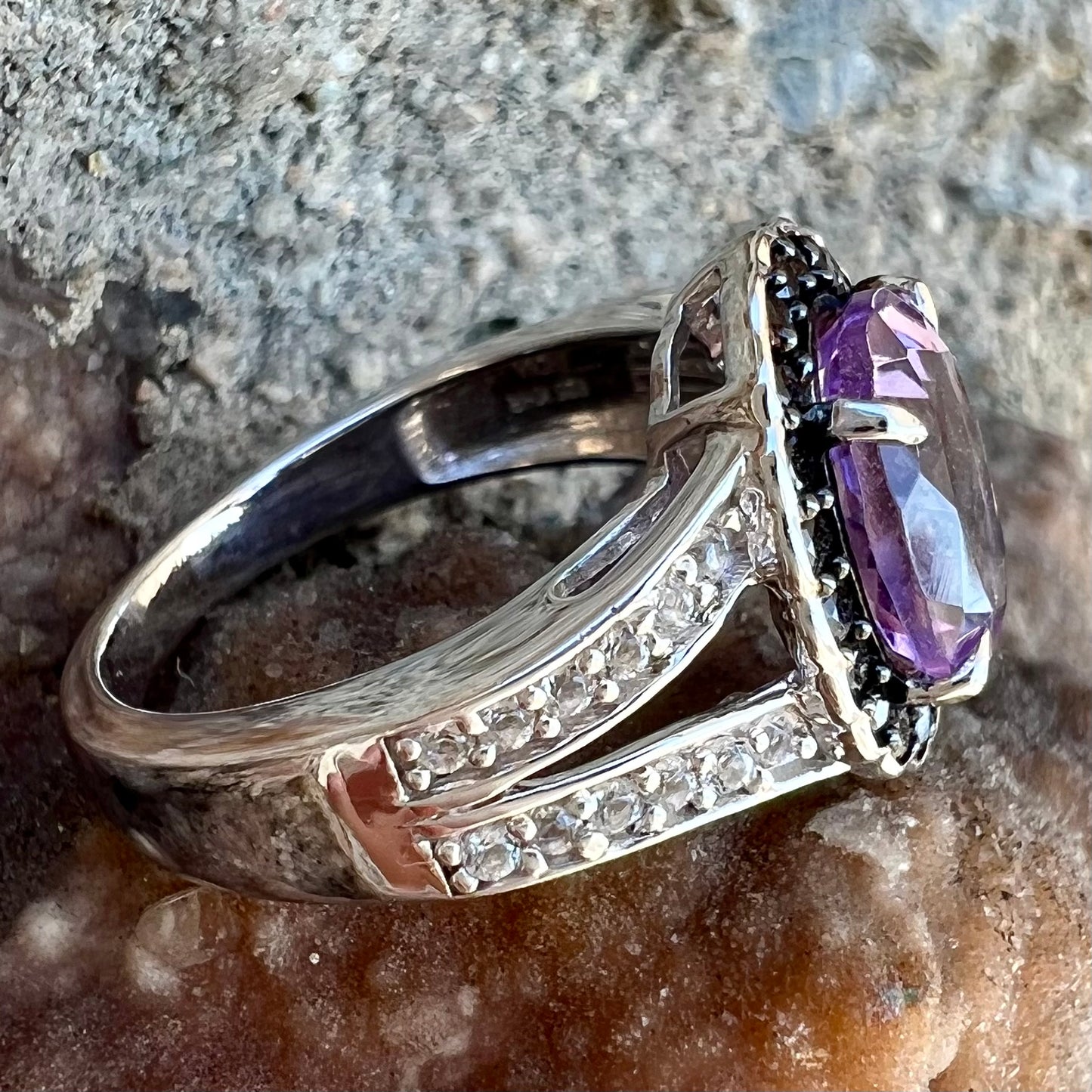 Sterling silver ladies' ring made with Rose de France amethyst set in a black spinel halo with white topaz accents.