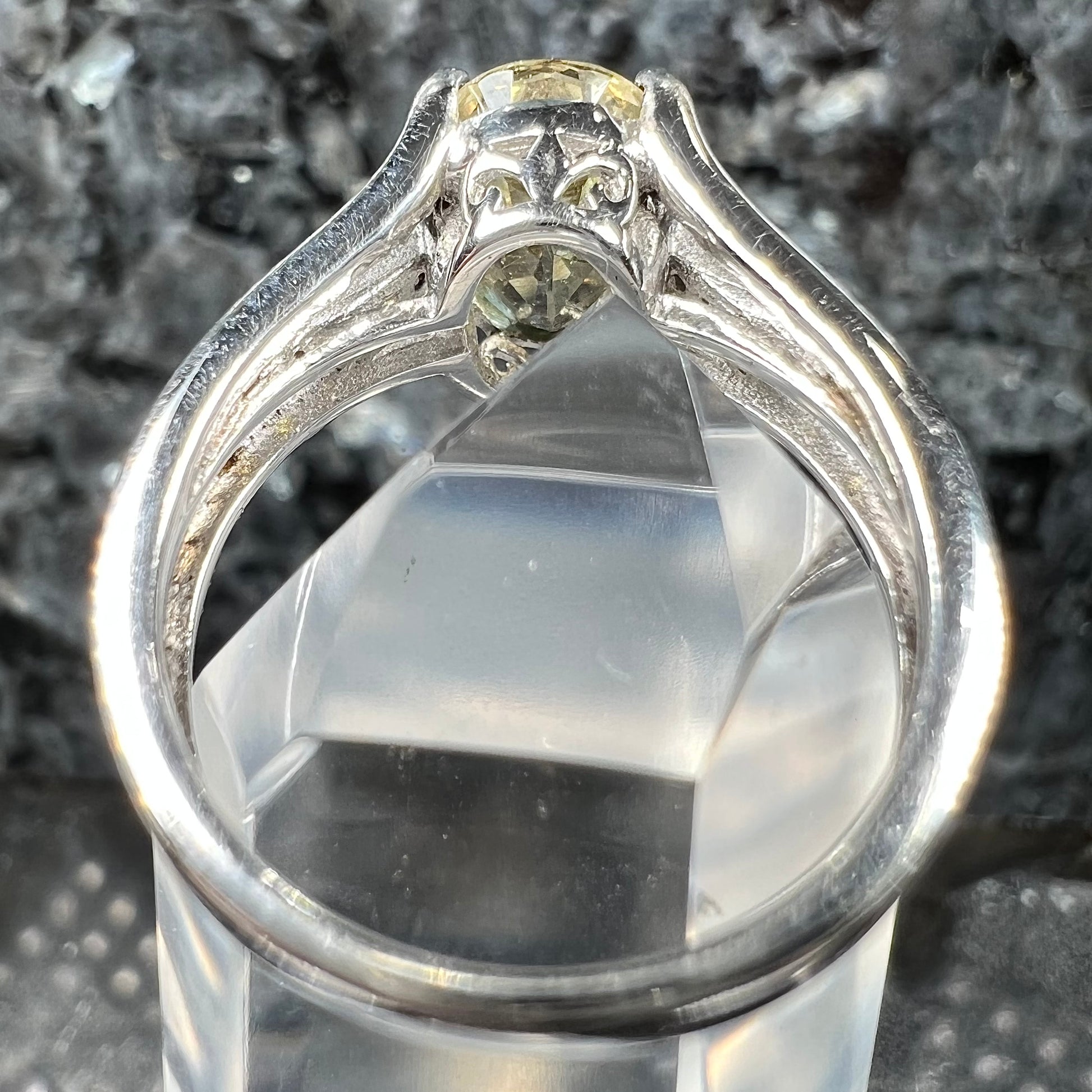 A sterling silver oval cut citrine ring set with canary yellow diamond accents.