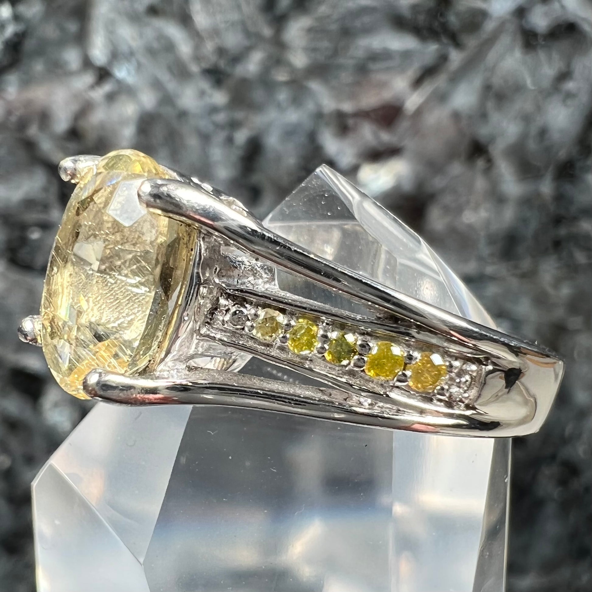 A sterling silver oval cut citrine ring set with canary yellow diamond accents.
