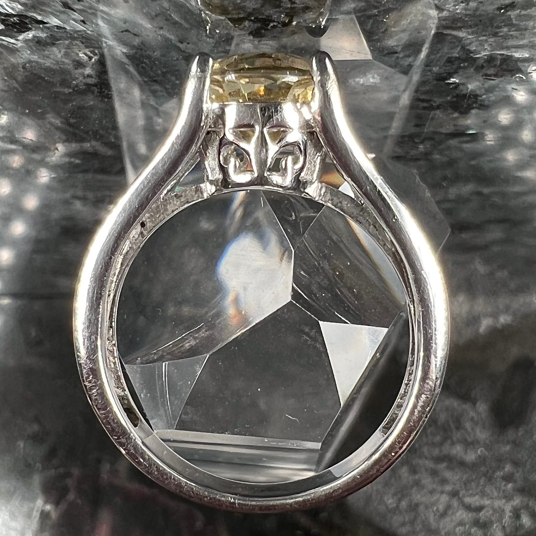 A sterling silver oval cut citrine ring set with canary yellow diamond accents.