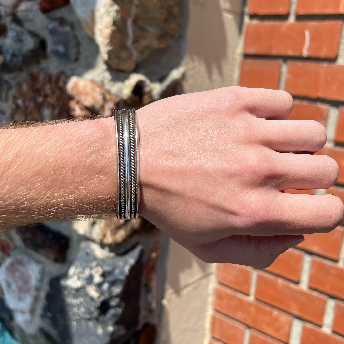 A handmade sterling silver cuff bracelet. The bracelet is made with a rope wire.