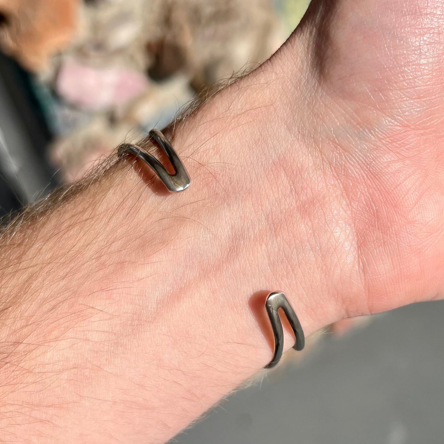 A silver ladies' turquoise and coral cuff bracelet, handmade by Navajo artist, John Delvin.