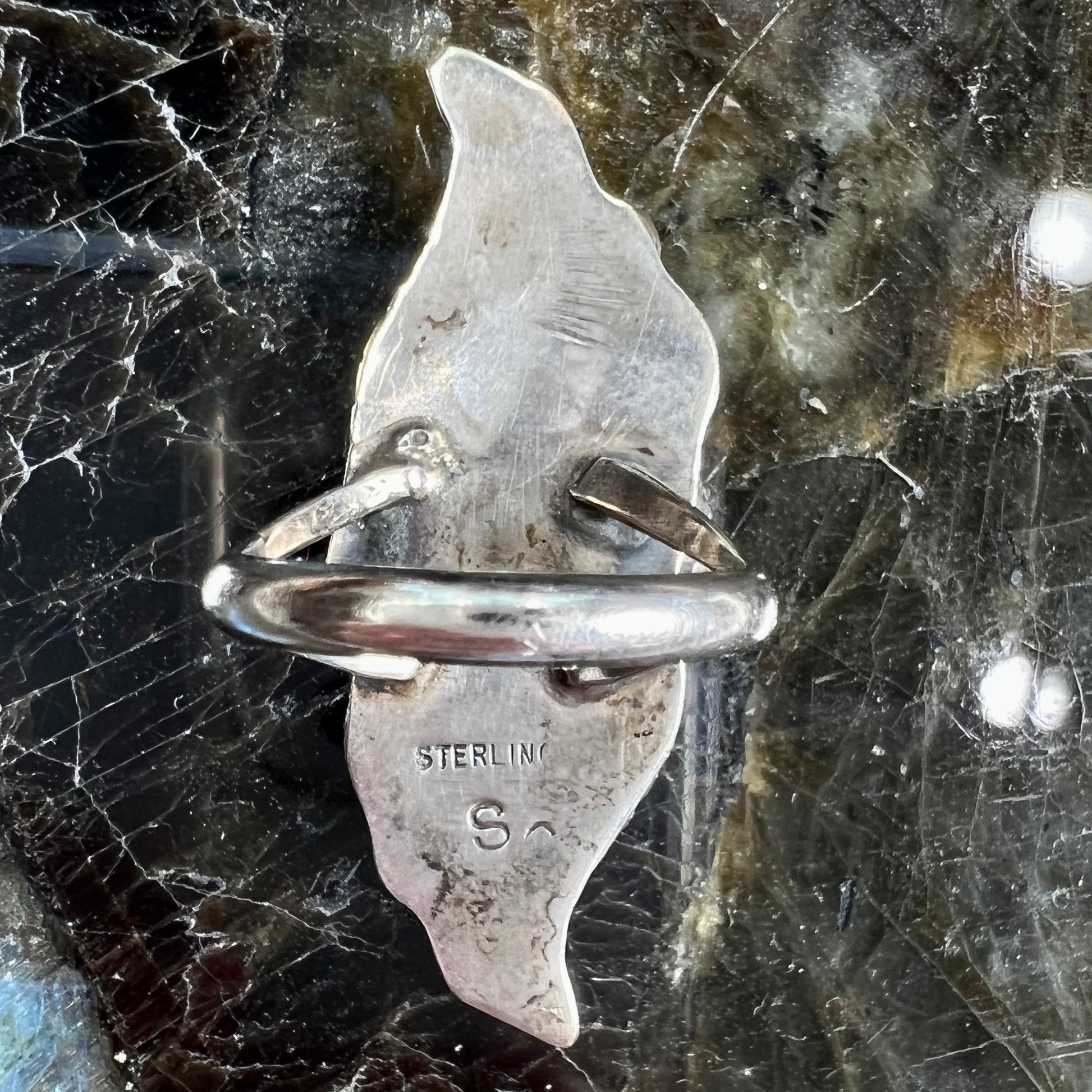 A sterling silver Navajo flower ring.