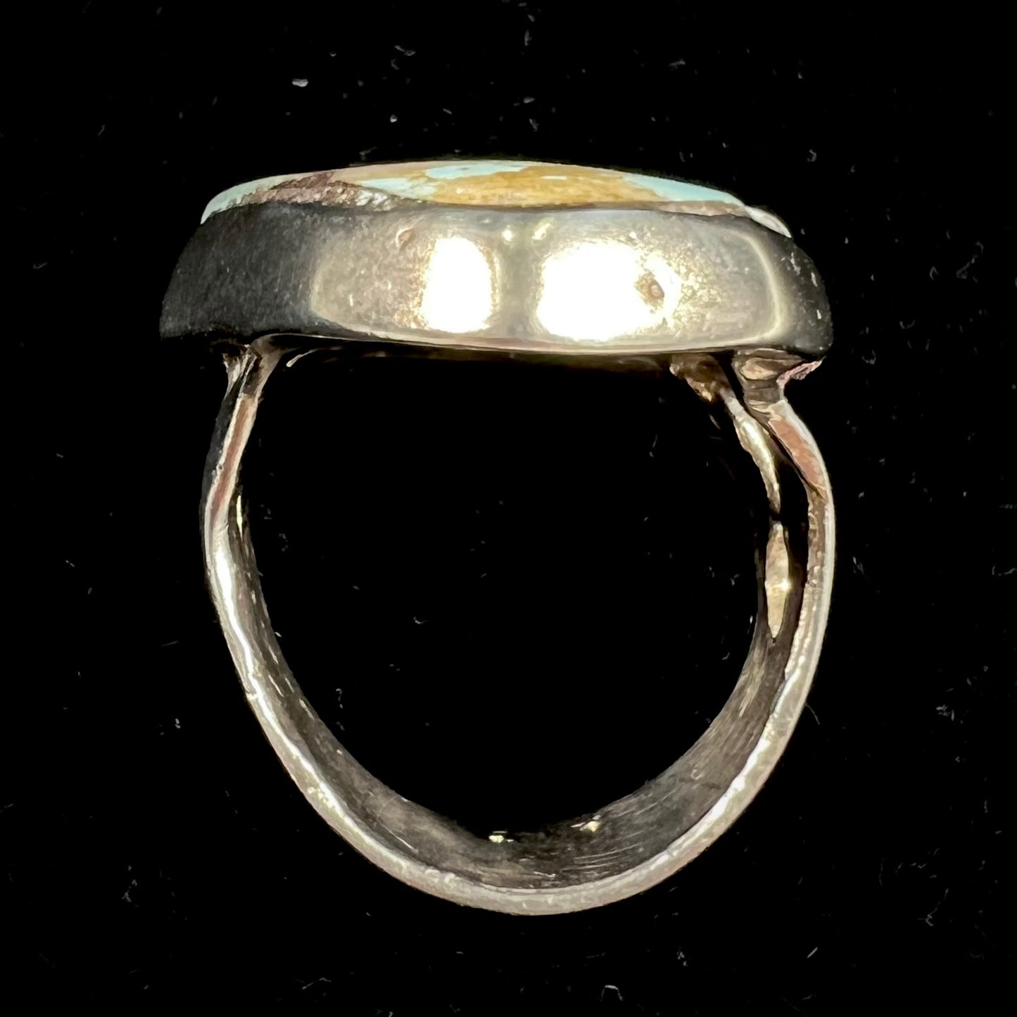 A men's sterling silver ring set with a powder blue turquoise stone. The ring is rustic style.