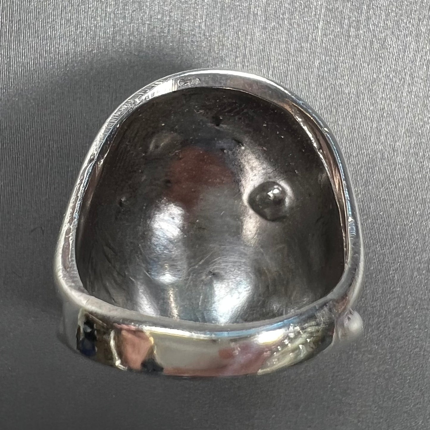 A handmade, unisex Hopi silver ring set with 14 round turquoise cabochons.